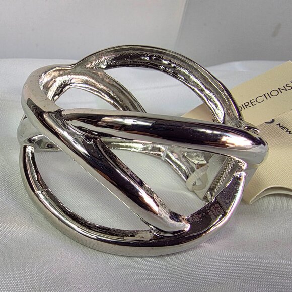 New Directions Silver Tone Knot Bangle Bracelet Featuring an Abstract Design - Picture 3 of 10